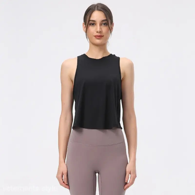 Woman wearing a black sleeveless top and mauve leggings showcasing the Chinese Olive Green and Midnight Blue Sporty Nylon Half Waist Blouse