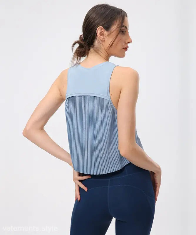 Light blue sleeveless half waist blouse with pleated back panel in Chinese Olive Green and Midnight Blue