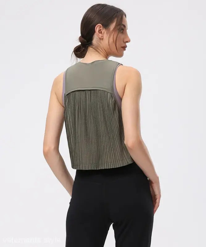 Sleeveless Chinese Olive Green half waist blouse with pleated back paired with black pants