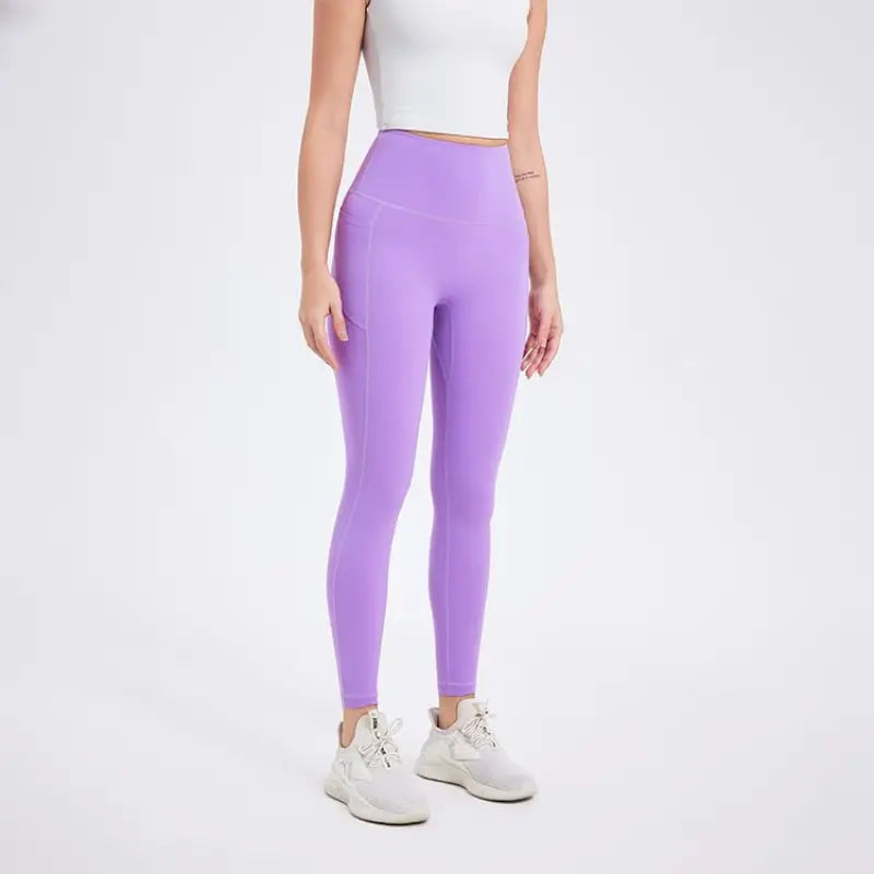 Deep smoky gray sporty nylon pants with lavender leggings and white tank top
