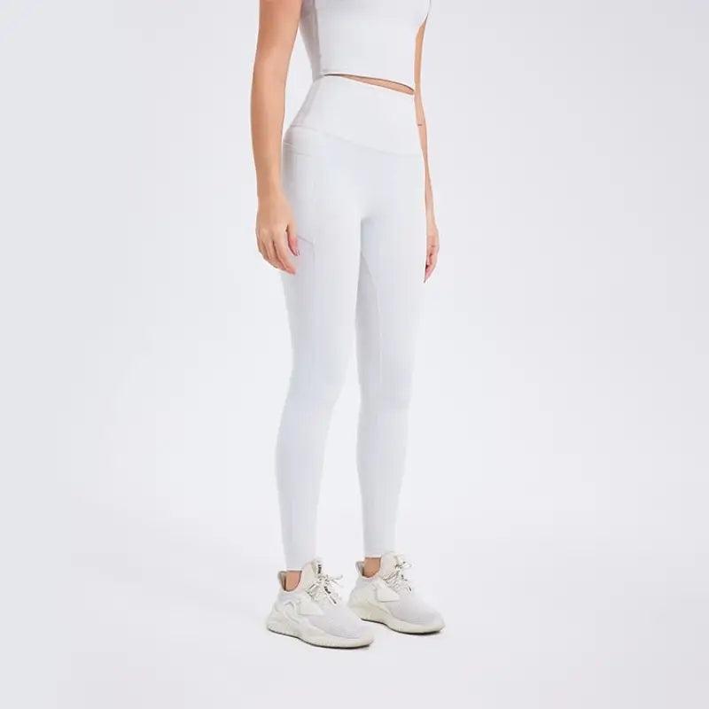 Deep smoky gray sporty nylon pants with white leggings, rose gold waistband, sneakers