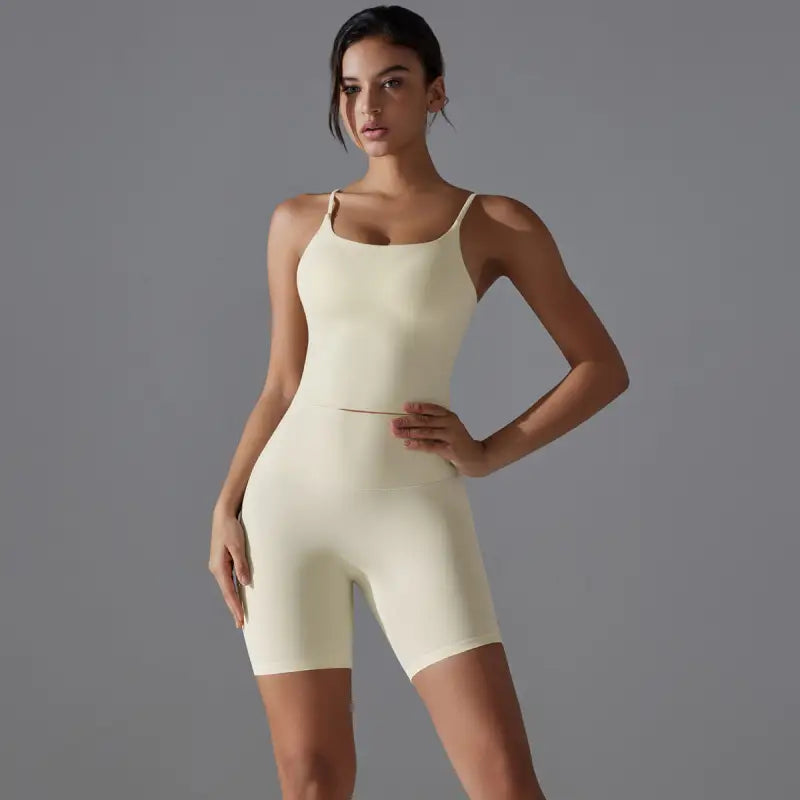 Woman wearing yellow athletic bodysuit with summer shorts yoga for active wear