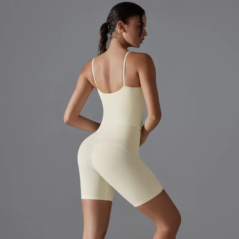 Cream-colored, form-fitting bodysuit ideal for summer shorts yoga and yoga set activities