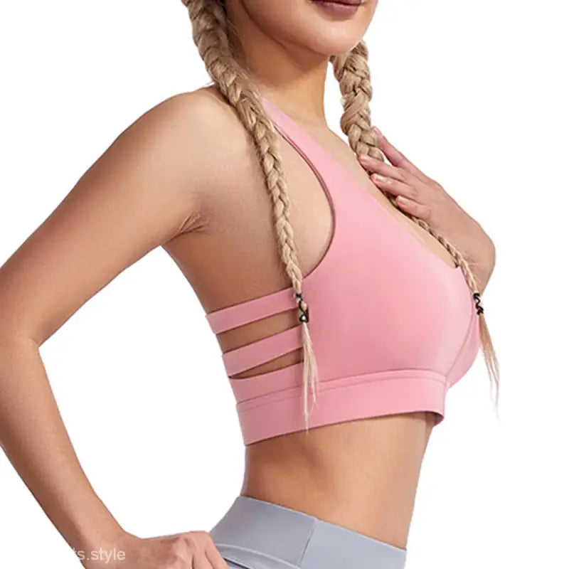 Pink sports bra with strap details, featuring steel ring design for boost shape support