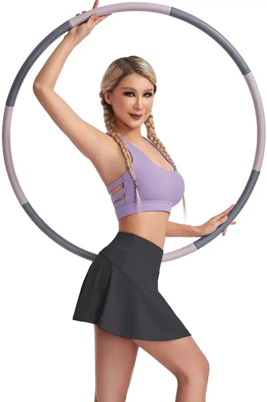 Woman demonstrating fitness with a hula hoop wearing a boost shape workout bra with steel ring