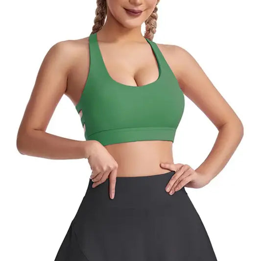 Woman wearing a green boost shape bra and black skirt, showcasing the Workout Bra design