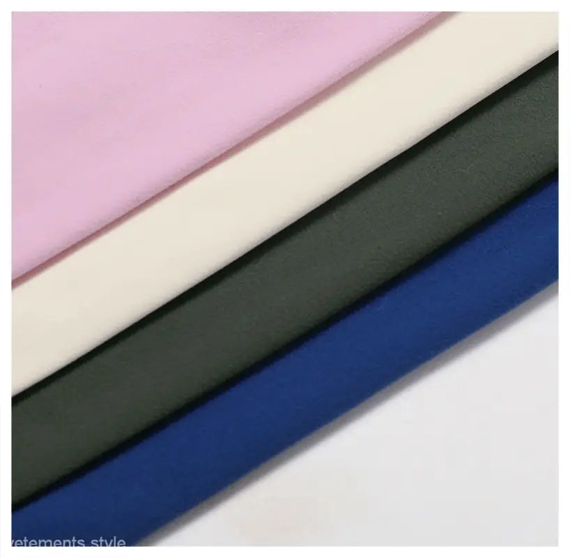 Diagonal fabric strips in pink, cream, dark gray green, and night sky blue for Sporty Nylon Solid Pants