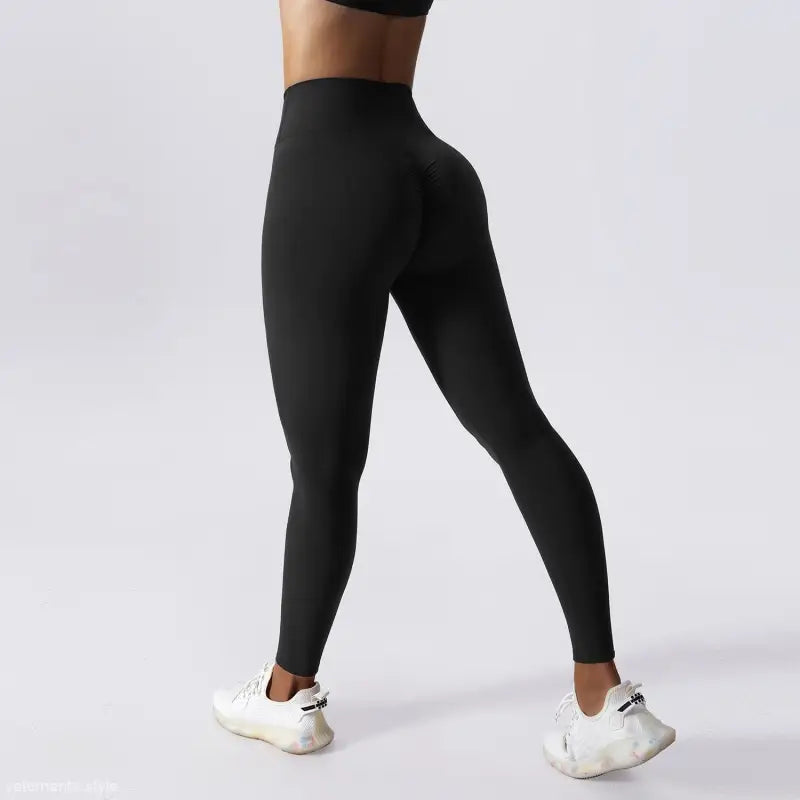 Black high-waisted athletic leggings paired with white sneakers for Sporty Nylon Solid Pants