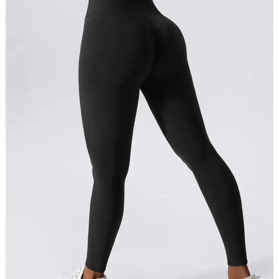 Black high-waisted athletic leggings styled with white sneakers, perfect for workouts