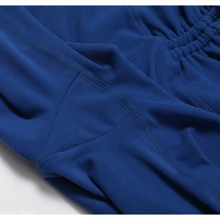 Blue athletic shorts featuring visible seams and an elastic waistband in Sporty Nylon Solid Pants