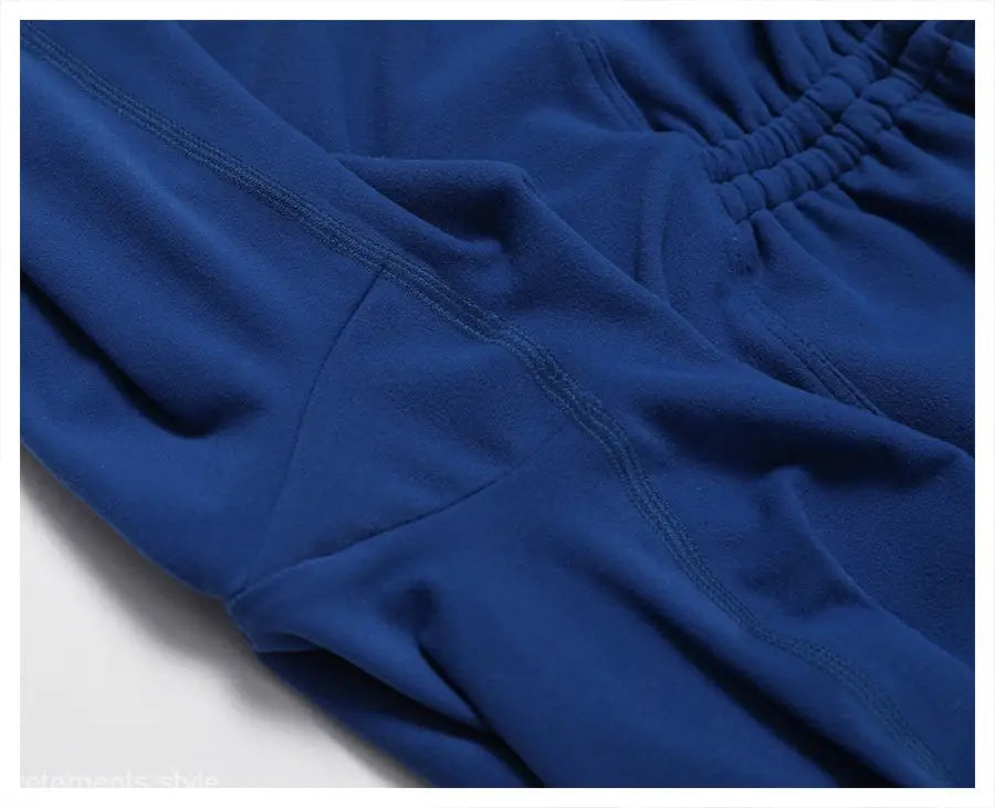 Blue athletic shorts featuring visible seams and an elastic waistband in Sporty Nylon Solid Pants