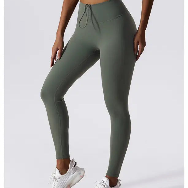 Olive green high-waisted athletic leggings with a drawstring waistband in Sporty Nylon Solid Pants