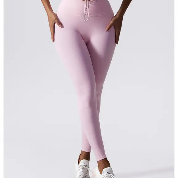 Pale pink high-waisted leggings styled with white sneakers from Sporty Nylon Solid Pants