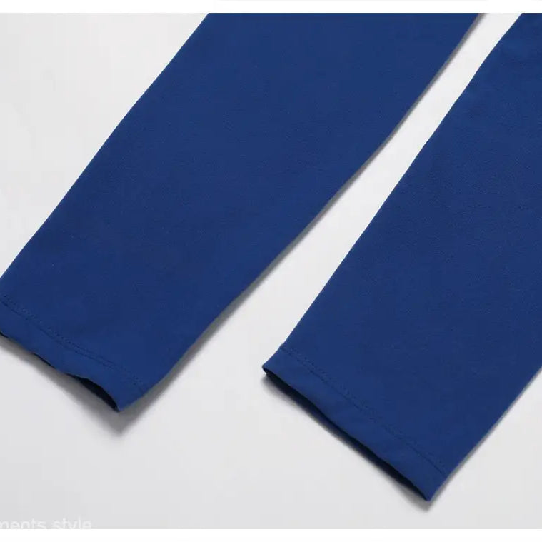 Two blue fabric sleeves from Sporty Nylon Solid Pants in Night Sky Blue