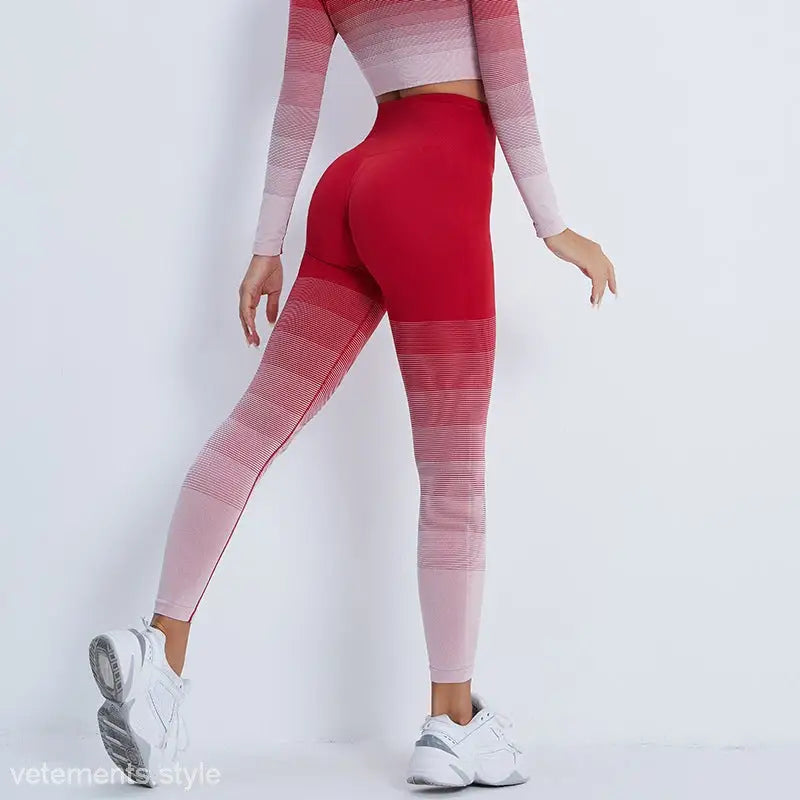 Red and pink ombré workout leggings with matching crop top and white sneakers for active wear