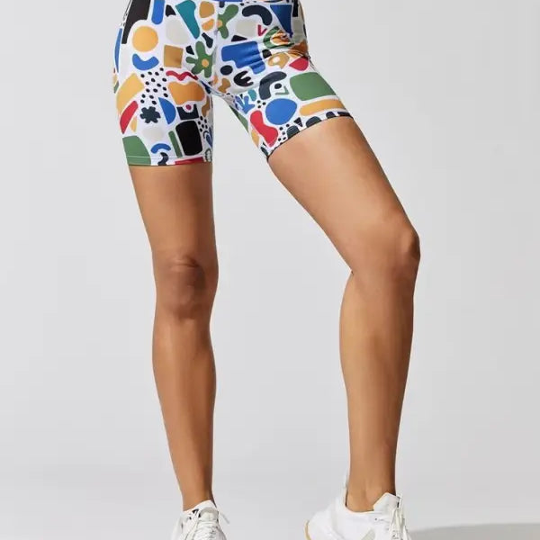Colorful patterned cycling shorts paired with white sneakers in a Printing Elastic Fitness Suit