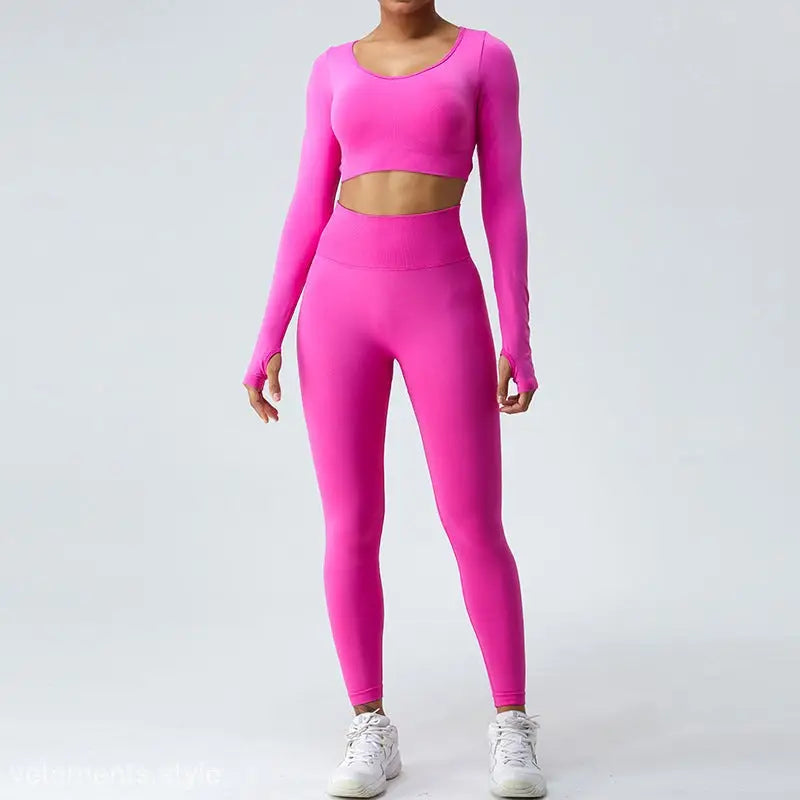 Bright pink workout outfit featuring a long-sleeved crop top and high-waisted leggings in Coral Red and Klein Blue for a Fit Pulse active look