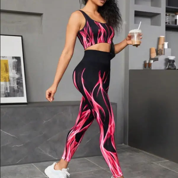 Woman in a black and pink flame-patterned high elastic fitness two-piece workout set