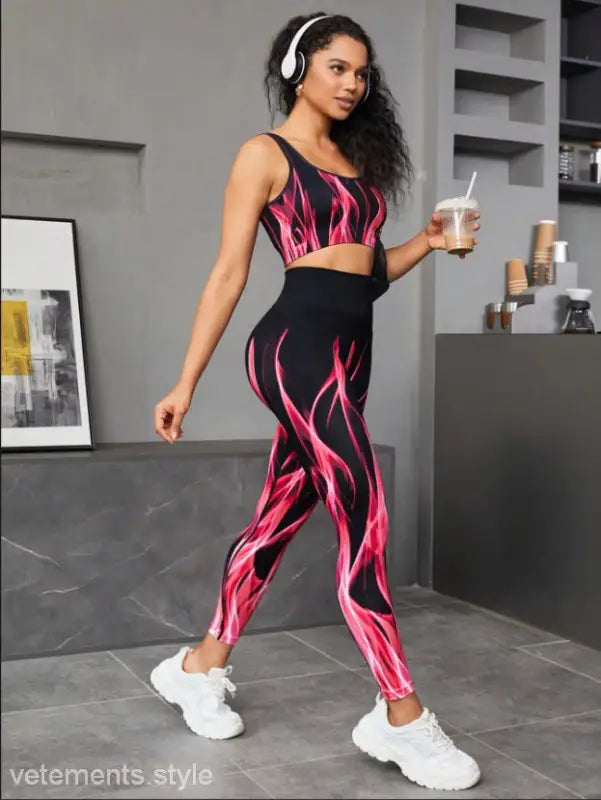 Woman in a black and pink flame-patterned high elastic fitness two-piece workout set
