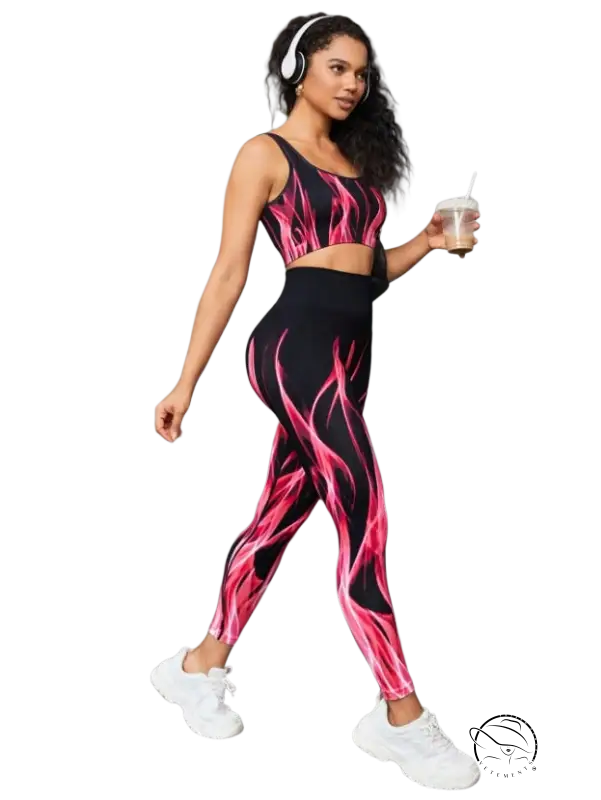 Woman in high elastic fitness two-piece set with flame pattern and headphones