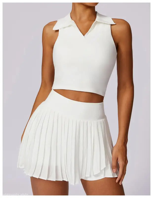 White sleeveless crop top and pleated mini skirt set in Swan White Suit for stylish looks
