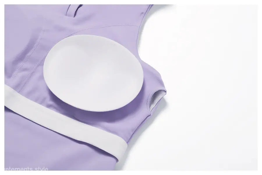 White circular nursing pad on light purple fabric with Sporty Slim Nylon High Rise Bottom in Swan White Suit
