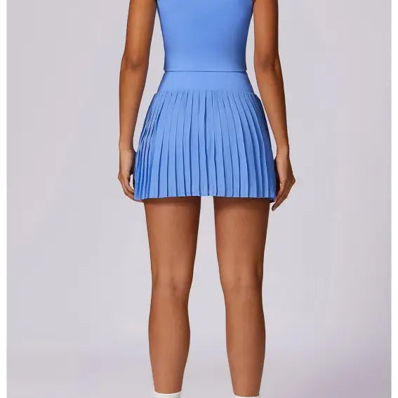 Light blue sleeveless tennis dress with pleated skirt for Swan White Suit collection