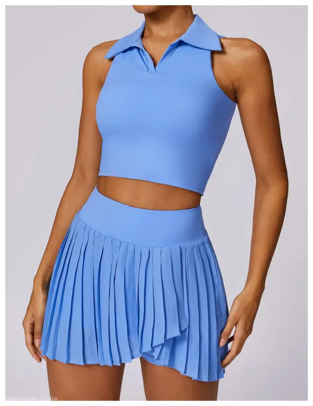 Light blue two-piece outfit featuring a sleeveless crop top and pleated mini skirt in Swan White Suit