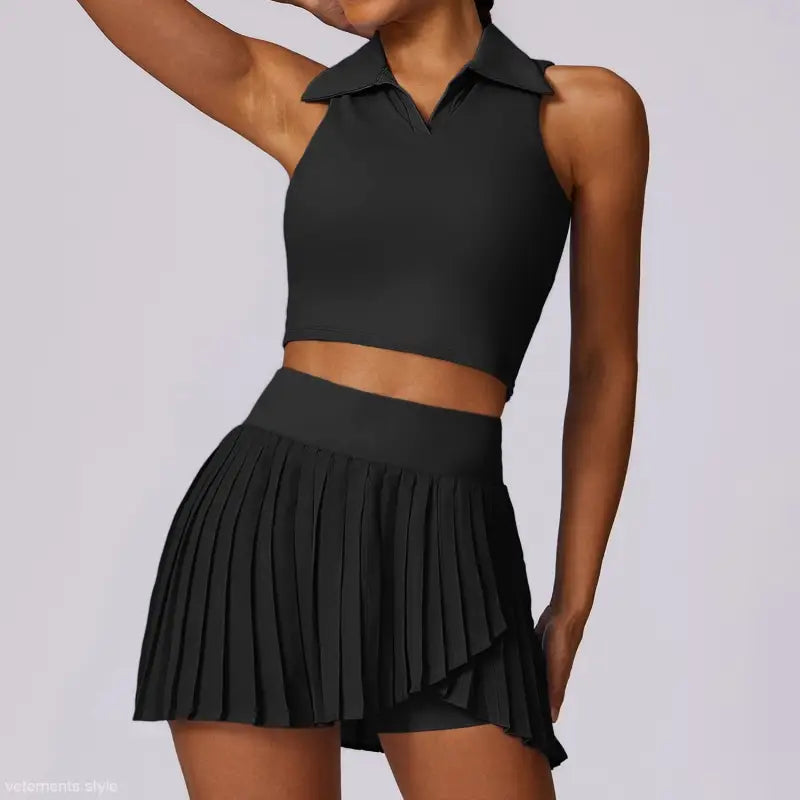 Black two-piece outfit featuring a sleeveless crop top and pleated mini skirt in Swan White Suit