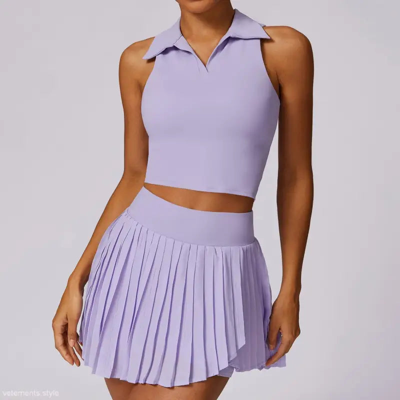 Lavender two-piece outfit featuring a sleeveless collared crop top and pleated mini skirt