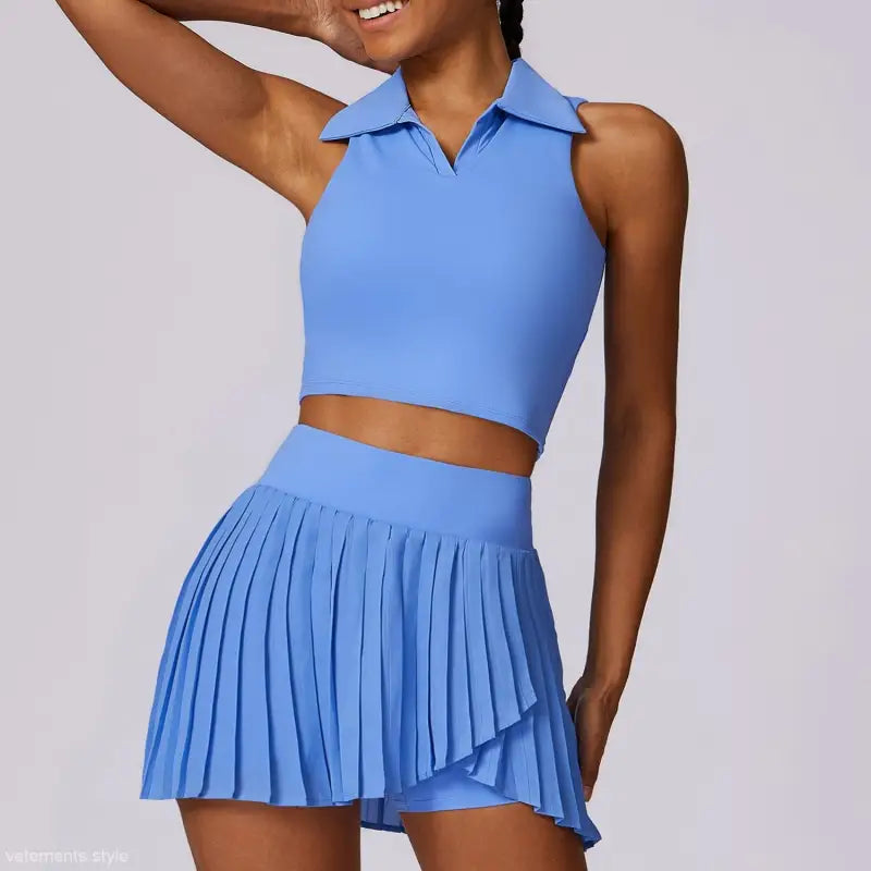 Blue two-piece outfit featuring a sleeveless crop top and pleated mini skirt in Swan White Suit