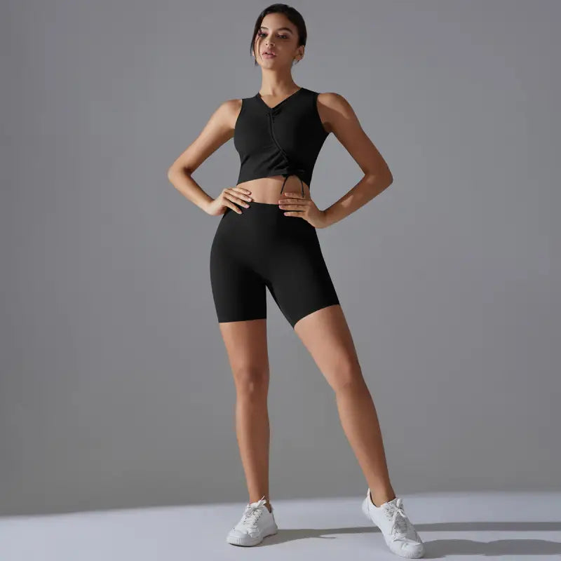 Woman in black athletic wear demonstrating the Sporty Slim Nylon Sleeveless High Rise Yoga Set for Fitness Yoga