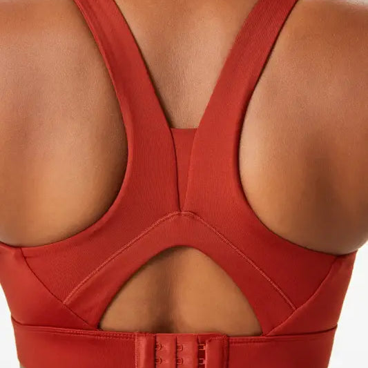 Rust-colored sports bra with integrated mold cup and cutout back for activewear