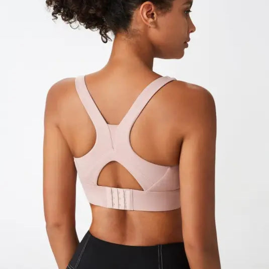 Light pink sport bra with integrated mold cup and cutout back for optimal support