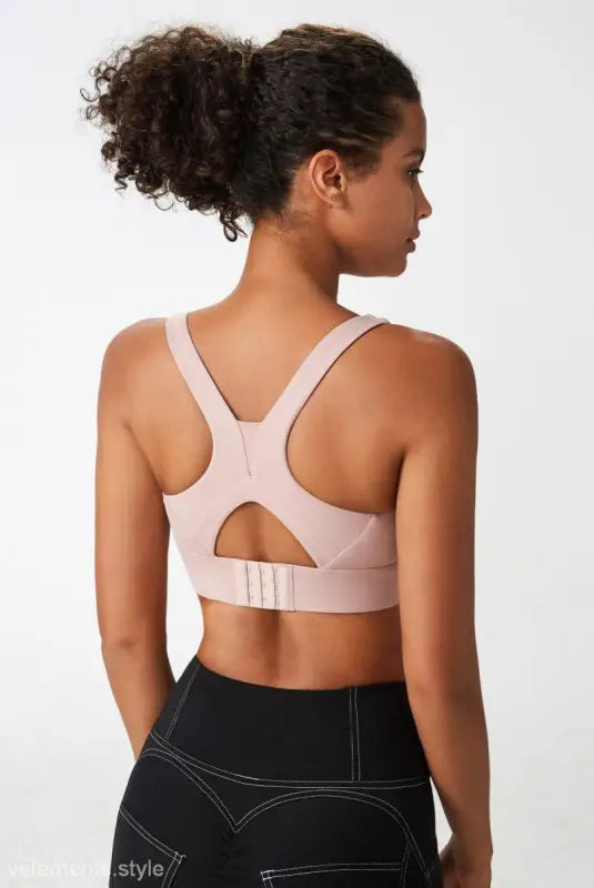 Light pink sport bra with integrated mold cup and cutout back for optimal support
