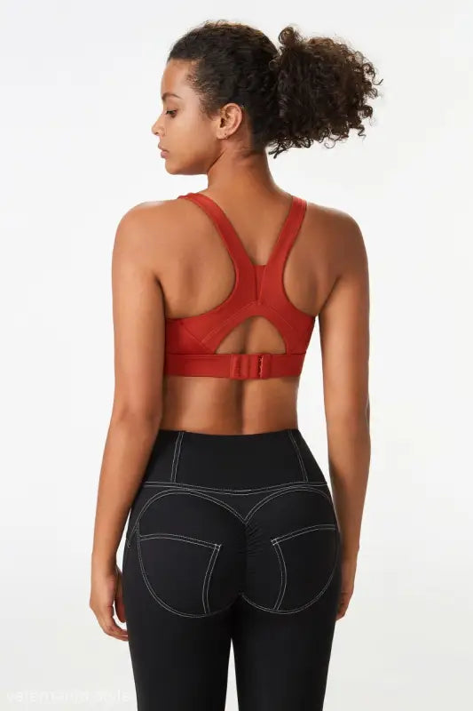 Woman in sports bra integrated with mold cup and cutout back leggings