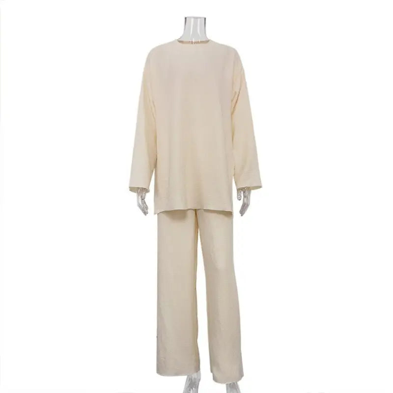 Cream-colored knit sweater and pants set on mannequin from Stitching Crepe Casual suit