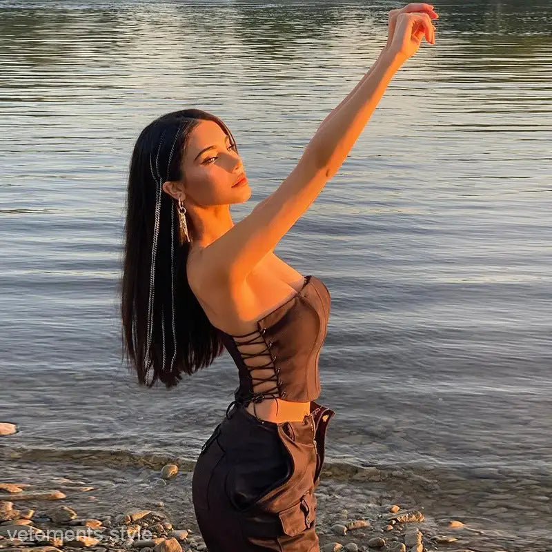 Woman wearing a Strap Boning Corset Top with Lace-Up Detail and cargo pants for summer elegance