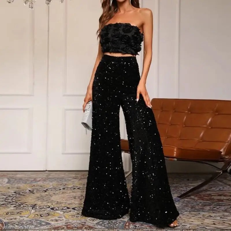 Glamorous black two-piece outfit with floral strapless top and sequined high waist pants