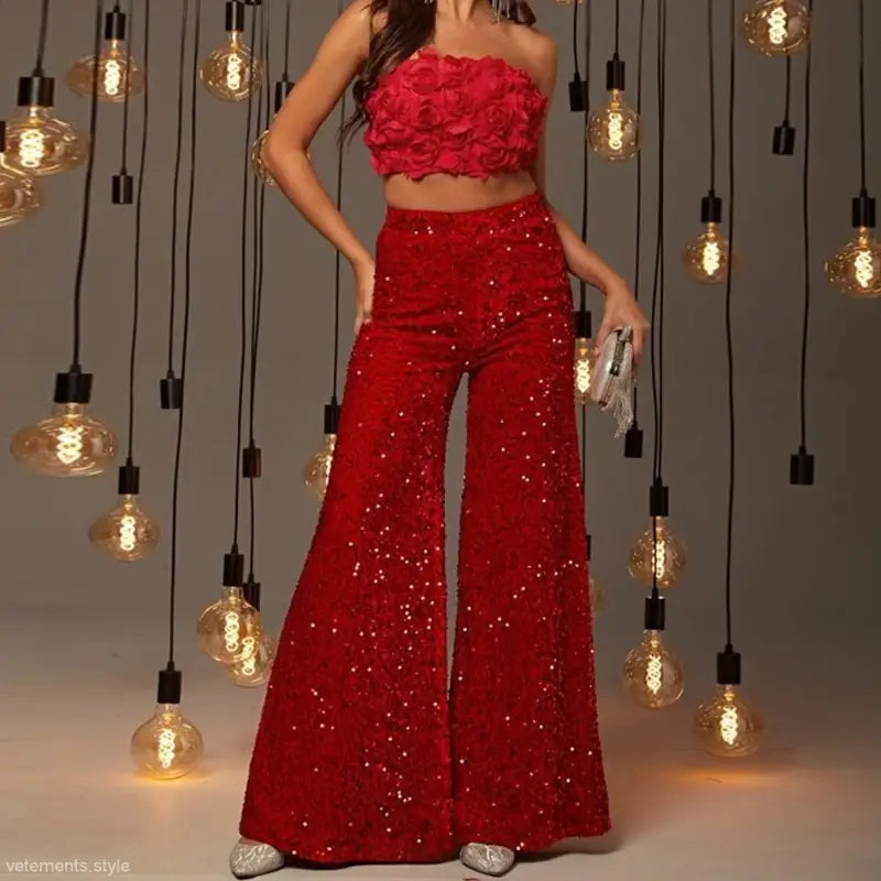 Red sequined two-piece outfit with rose-covered crop top and wide-leg pants for stunning pinky suits
