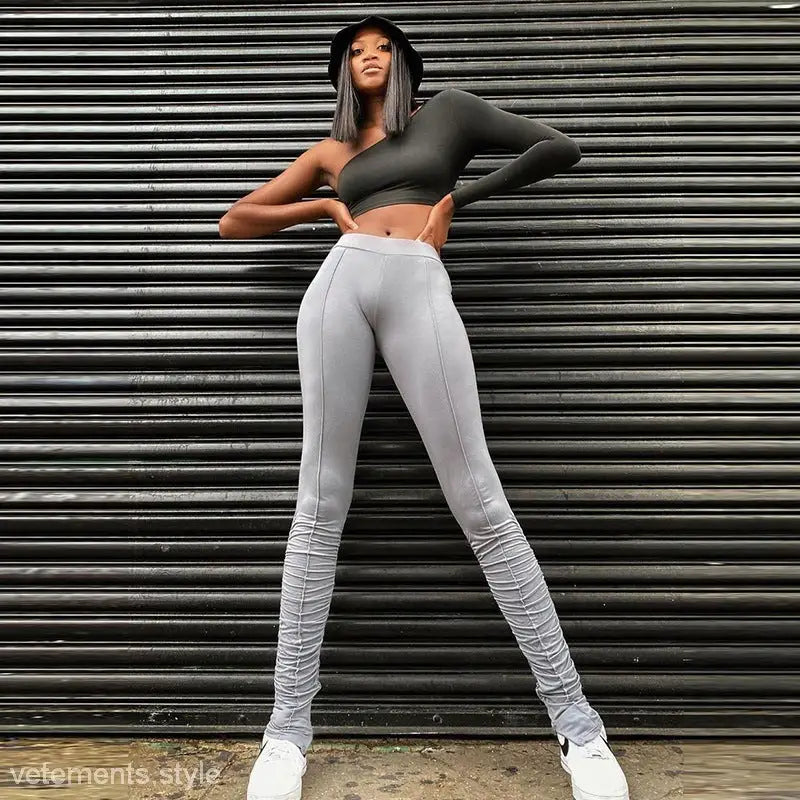 Woman posing confidently in high waist slim fit seasonless leggings with ruched design