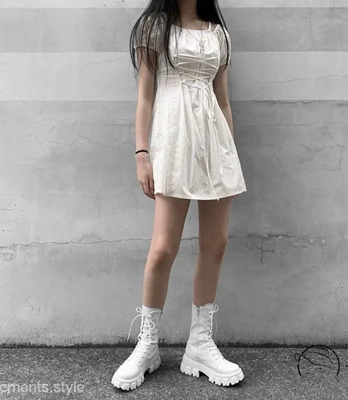 White mini dress with stylish lace-up platform boots