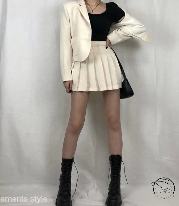 Woman in stylish lace-up platform boots, white blazer, black top, white skirt