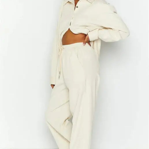 Woman in a beige cardigan trousers suit set for fall and winter fashion