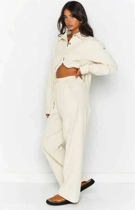 Woman in a beige cardigan trousers suit set for fall and winter fashion