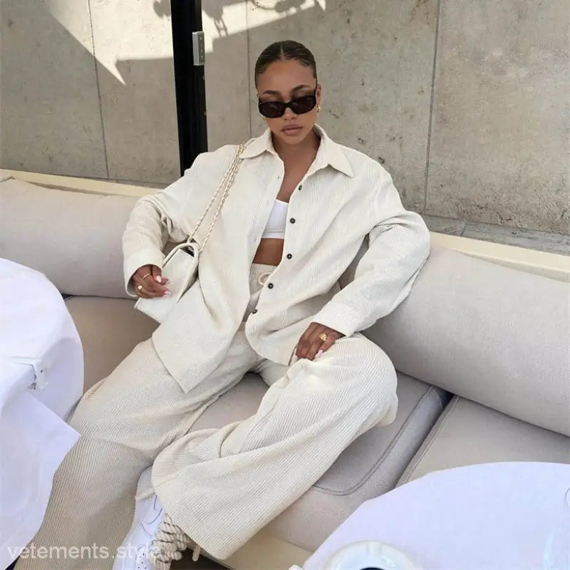 Woman in a white corduroy cardigan trousers suit for fall winter stylish two piece ensemble