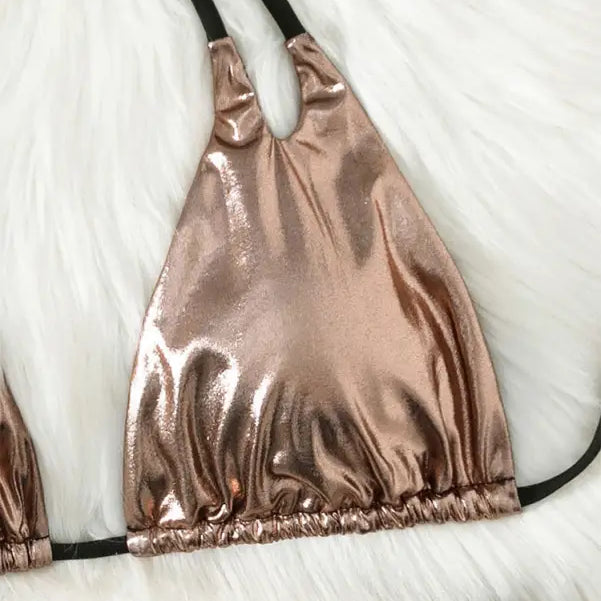 Rose gold metallic halter bikini top with black straps.
