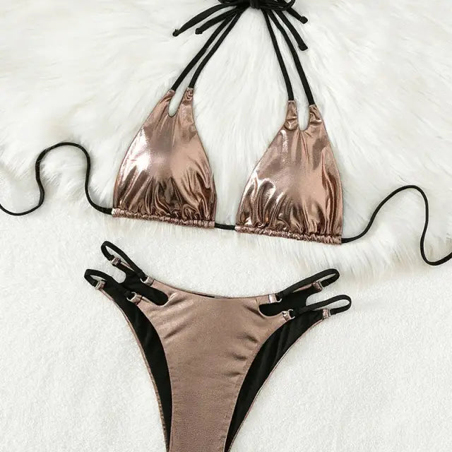 Rose gold metallic bikini with black straps and ties.