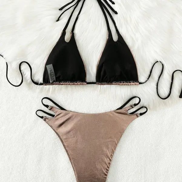 Two-piece bikini swimsuit with a black triangle top and metallic rose gold bottom.