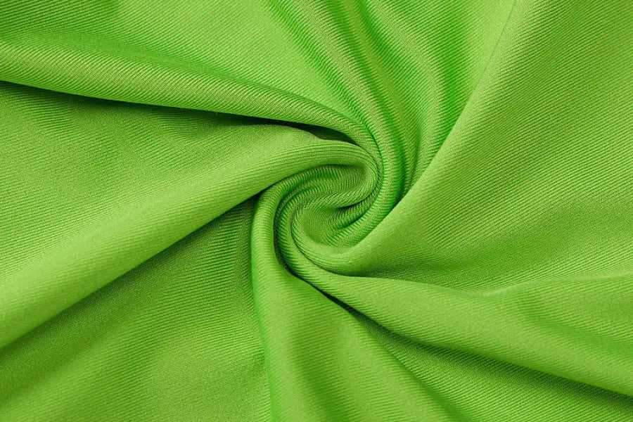 Bright green shoulder slim fit top with swirling pattern for hip raise yoga and summer activities